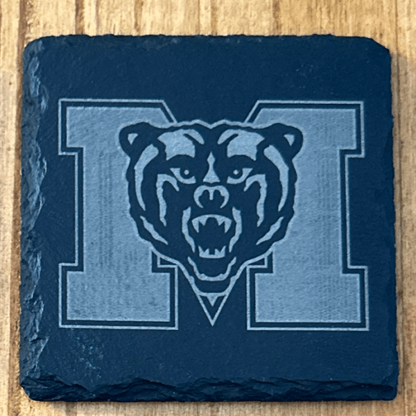 black slate coaster with the mercer logo